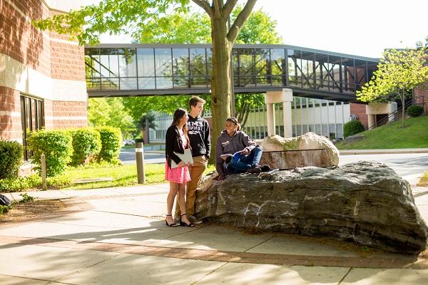students sitting on rock